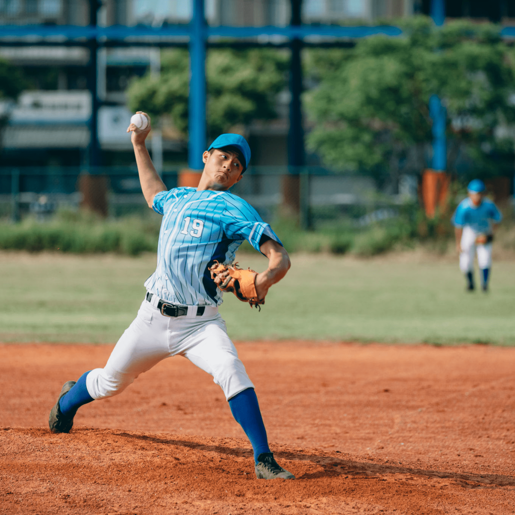 Baseball pitcher throwing on field