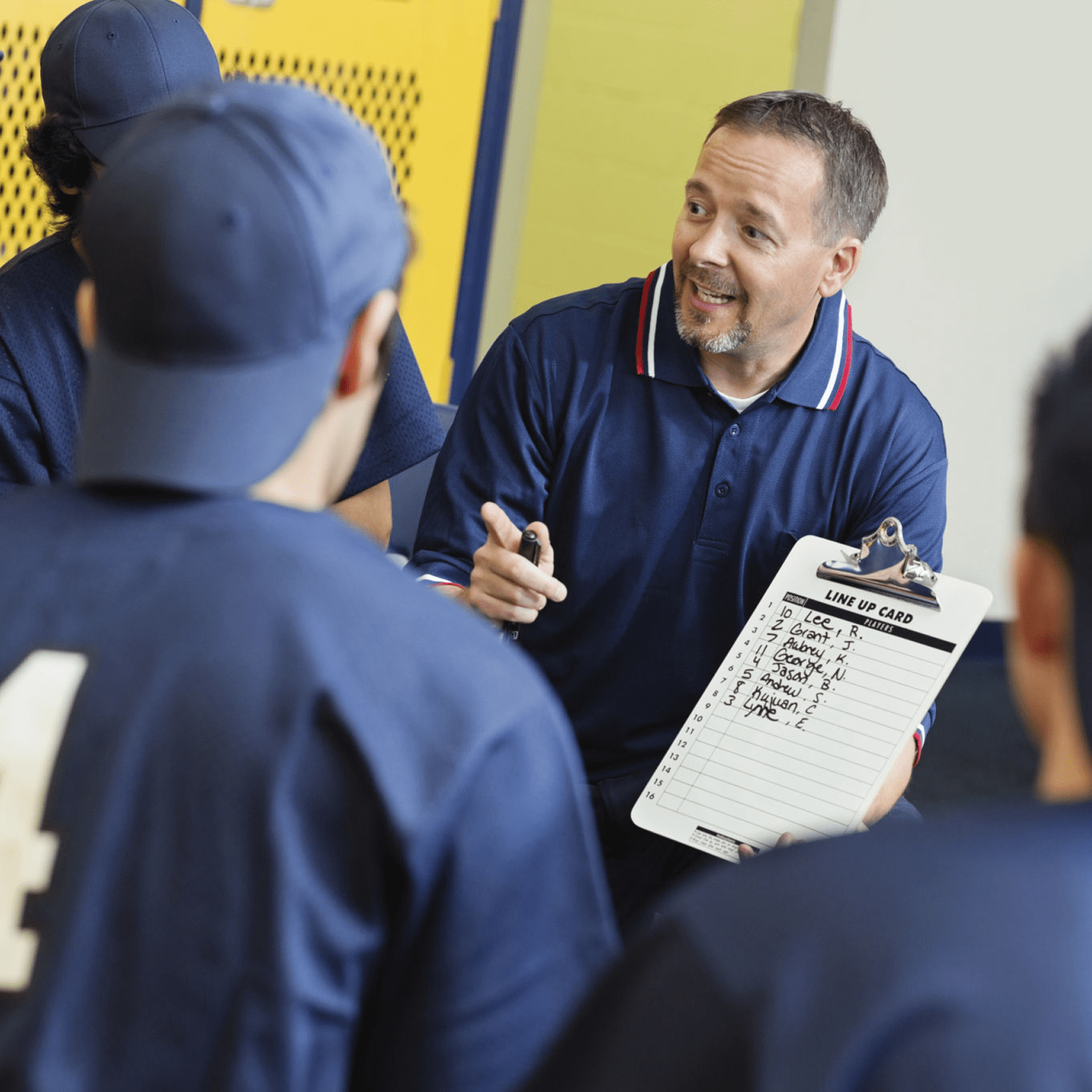 Baseball coach discussing strategy with team